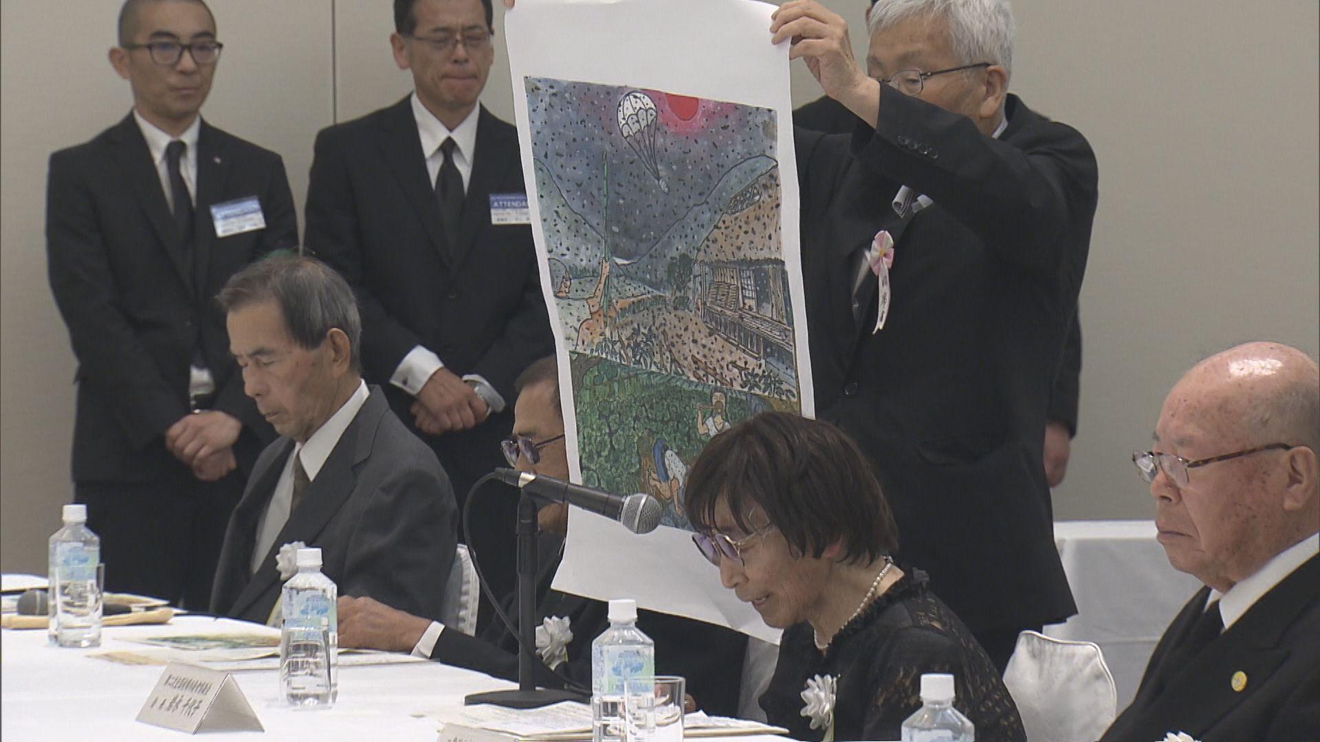 被爆体験者が描いた絵を見せて総理に被爆者認定を訴える原告団長の岩永千代子さん（８８）